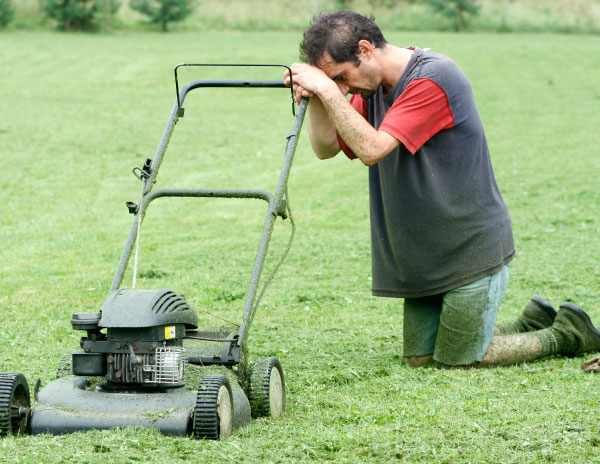 A guy in Tyler, TX mowing a lawn.